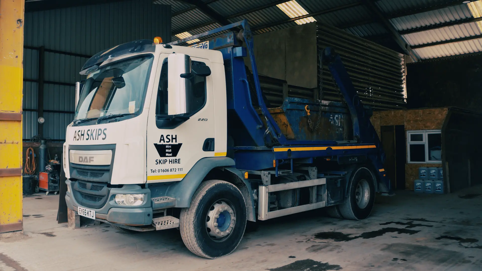 Truck loaded with a skip at Ash Skip Hire in Northwich, showcasing their waste management services with a fully loaded vehicle.